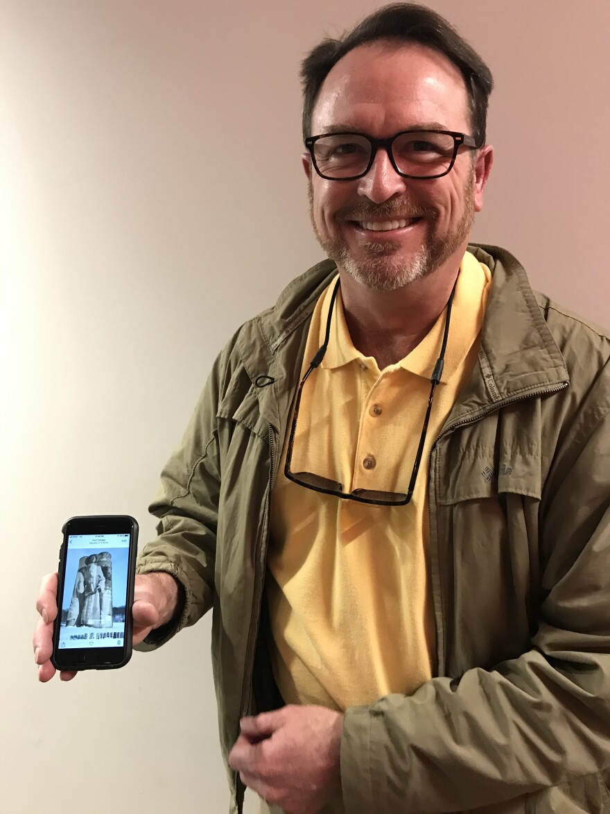 Joe Sullivan displays a picture of city-sanctioned public art - something he wishes graffiti artists did instead.