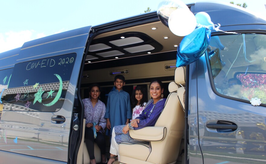 family members inside a van decorated with eid decor