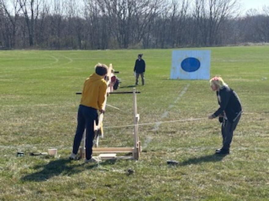 A high school team working on their trebuchet.