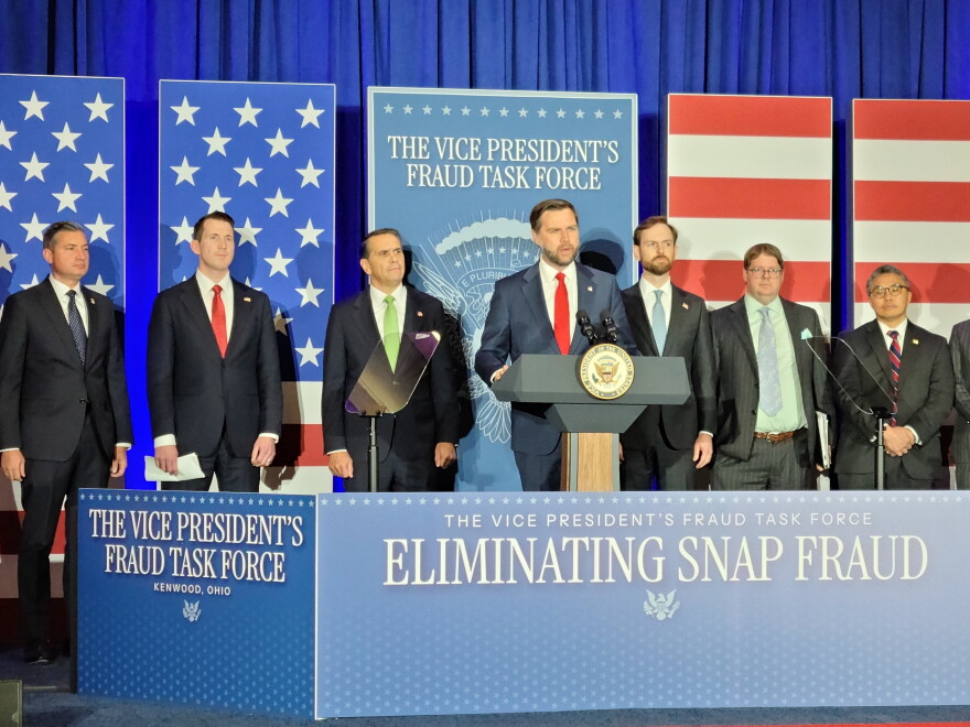 vp at a podium surrounded by signage about eliminating SNAP fraud