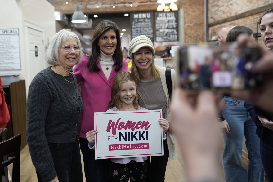 Republican presidential candidate former UN Ambassador Nikki Haley, second left, takes a photo with attendees during a campaign event at The Bread Board in Pella, Iowa, Monday, Jan. 15, 2024.