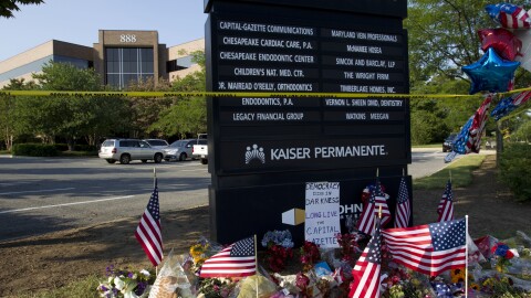 A makeshift memorial is seen outside the office building housing the Capital Gazette newsroom in Annapolis, Md., on Sunday.