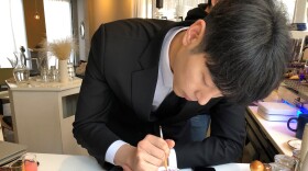 In this March 1, 2018, photo, Barista Lee Kang Bin applies the finishing touches to a recreation of a couple's Niagara Falls vacation photo, at his coffee shop in Seoul, South Korea.