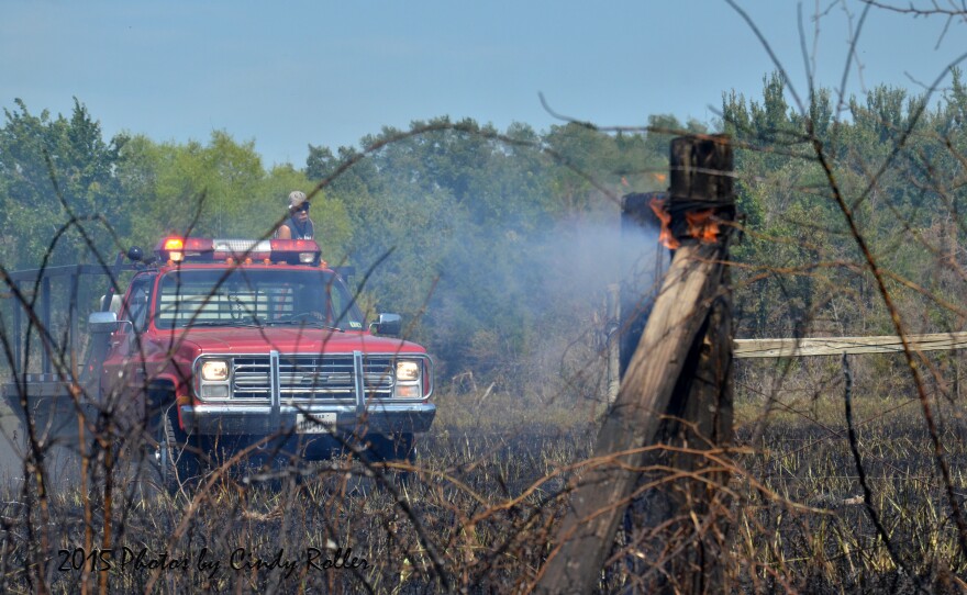 Enloe Volunteer Fire Fighters put out the hot spots of the grass fire Monday in triple digit heat.