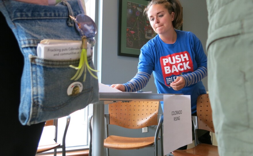 Emily Curnes of Colorado Rising prepares volunteers to knock on doors in Loveland, Colo., last month. The groups supports a ballot measure to keep oil and gas wells farther away from homes.