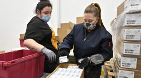Employees with the McKesson Corporation scan a box of the Johnson & Johnson COVID-19 vaccine while filling an order at their shipping facility in Shepherdsville, Ky., Monday, March 1, 2021.