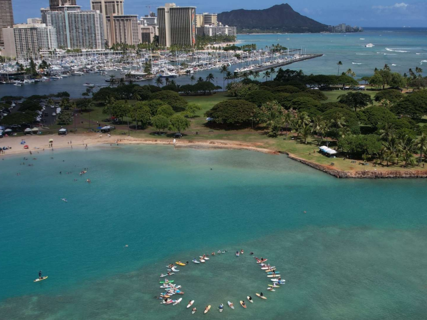 Local ocean advocacy groups gather for the paddle-out event near Honolulu on July 20, 2025.