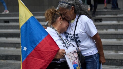 Barbara Bracho, left, mother of Gilberto Bracho, is embraced by Zoraida Gonzalez, mother of Miguel Estrada, both of whom consider their sons to be political prisoners, protest for their releases outside the United Nations office in Caracas, Venezuela, Wednesday Feb. 18, 2026. (AP Photo/Ariana Cubillos)