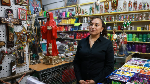 Isabel Pérez stands inside her shop at Long Bazaar on May 1, 2026, in Fort Worth. She has sold Mexican candy, botánica supplies and folk art at the site for 20 years. 