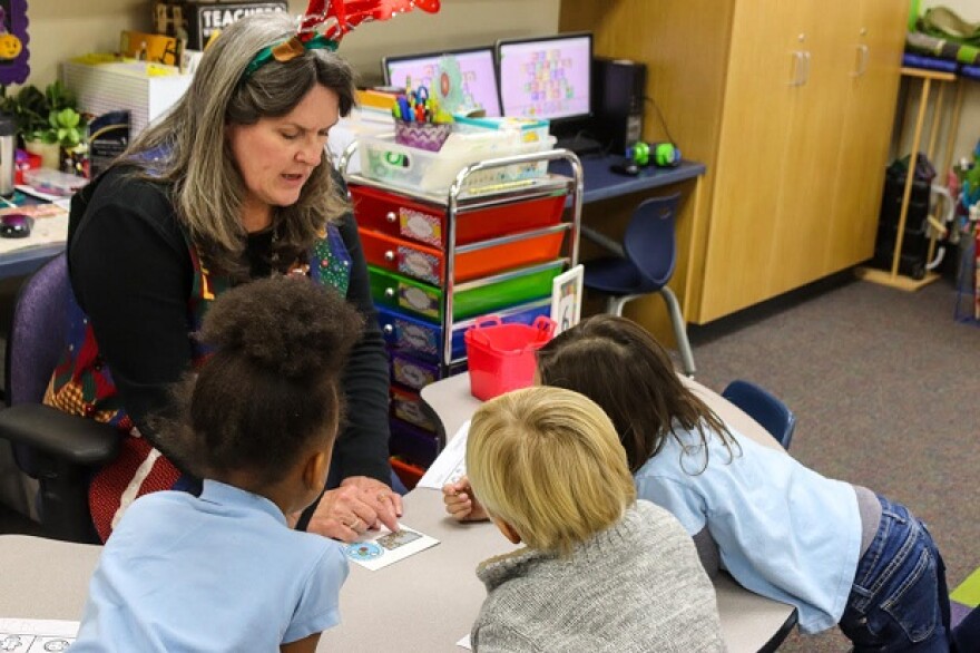 Preschool teacher, Irene Castell, works on counting with a small group of kids.