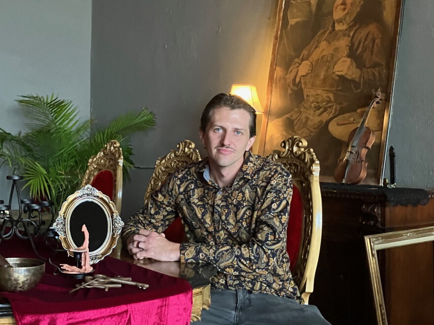 Matt Osborn, owner of The Half Nelson, sits at the table where seances will take place the nights of Oct. 27-31.