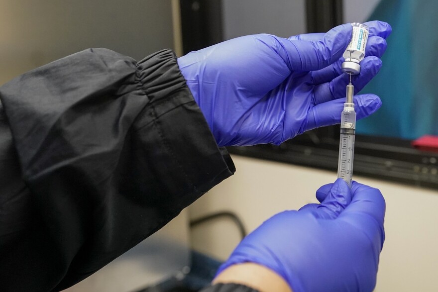 FILE - In this March 31, 2021, file photo, a nurse fills a syringe with a dose of Johnson & Johnson's COVID-19 vaccine in Uniondale, N.Y. (AP Photo/Mary Altaffer, File)