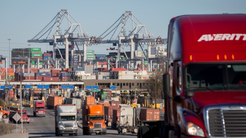 FILE- Tractor-trailers move cargo out of the Port of Savannah in Savannah, Ga., Jan. 30, 2018.