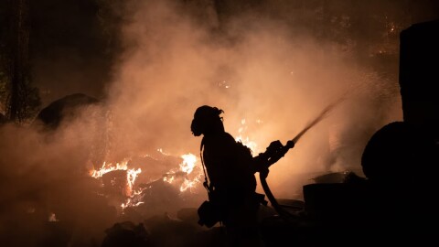 Firefighters protect homes in Christmas Valley from the Caldor Fire Monday, Aug. 30, 2021.