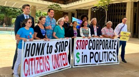 Hawaiʻi lawmakers and activists pose for a photo after discussing a bill that seeks to limit corporate money in politics in Honolulu on Thursday, April 23, 2026.