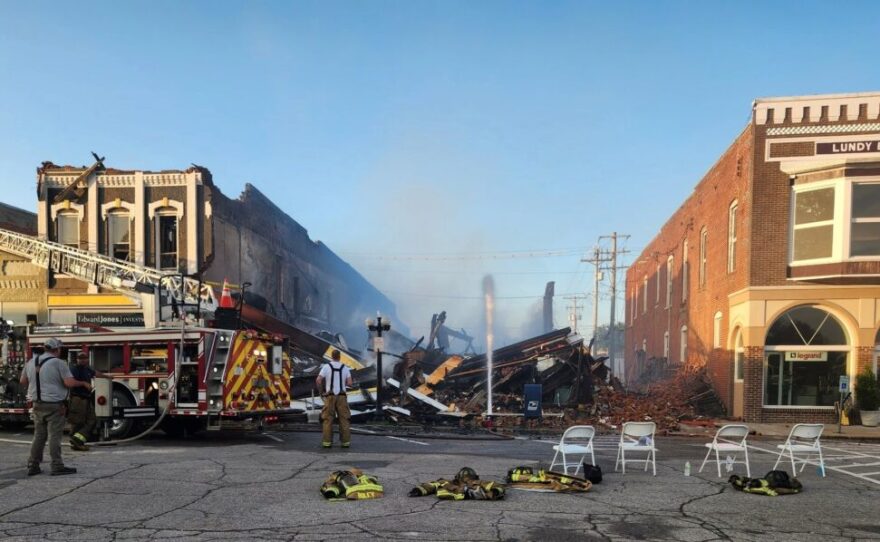 Fire crews monitor the site of a major fire in Albia's town square July 14, 2025.