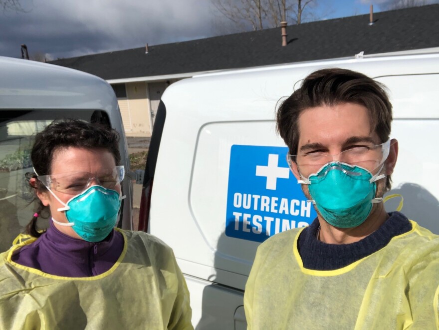 A woman and man in face masks. 