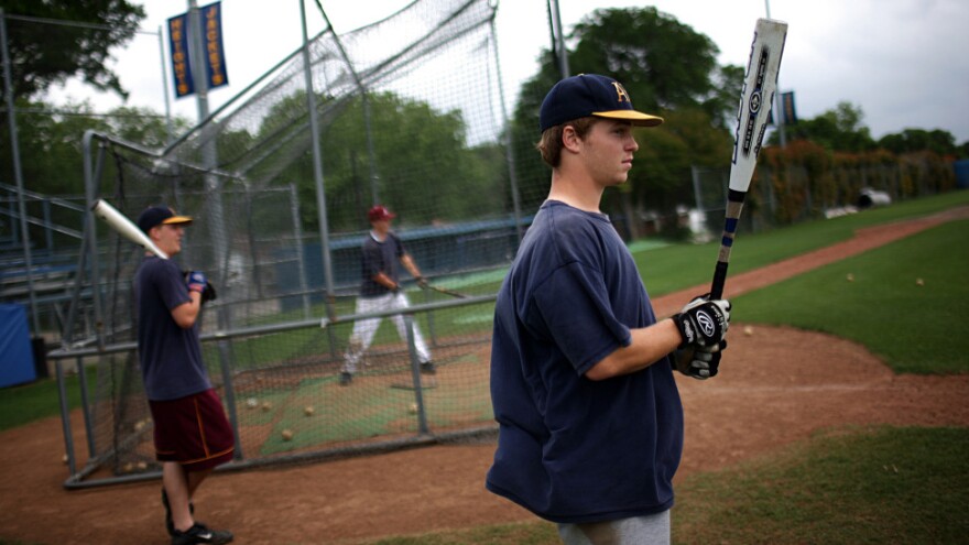 Members of the Arlington Heights High School baseball team swing their old-style aluminum bats during the 2009 season in Fort Worth, Texas. This year, high school players will use a different type of metal bat that's designed to reduce injuries.