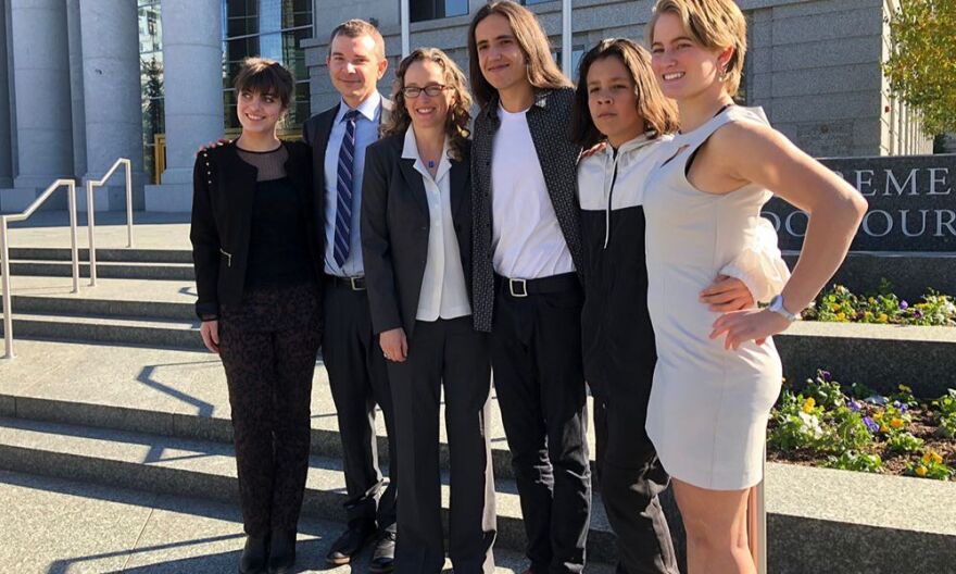 Young plaintiffs and their lawyers greet supporters and the media after a hearing before the Colorado Supreme Court in 2018. The "Martinez case," named for its lead plaintiff Xiuhtezcat| Martinez, seeks to force the Colorado Oil and Gas Conservation Commission to make public health and safety issues the priority when deciding on new drilling permits.