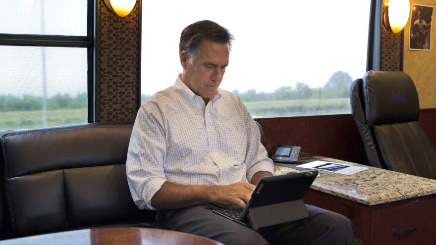 Mitt Romney, pictured riding on his campaign bus through Iowa during his 2012 presidential bid, has admitted to using a pseudonym on Twitter.