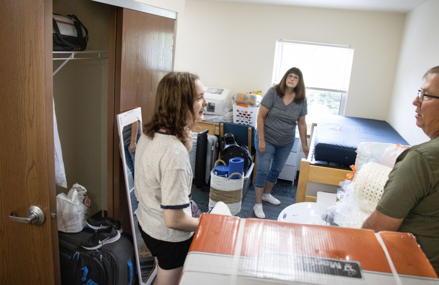 Abigail Durham, 18, moves into her dorm room at The University of Southern Indiana August 17, with the help of her parents Carol and Matt. Abigail said her peers still see the need to go to college. Carol said the need depends on the individual and the career.