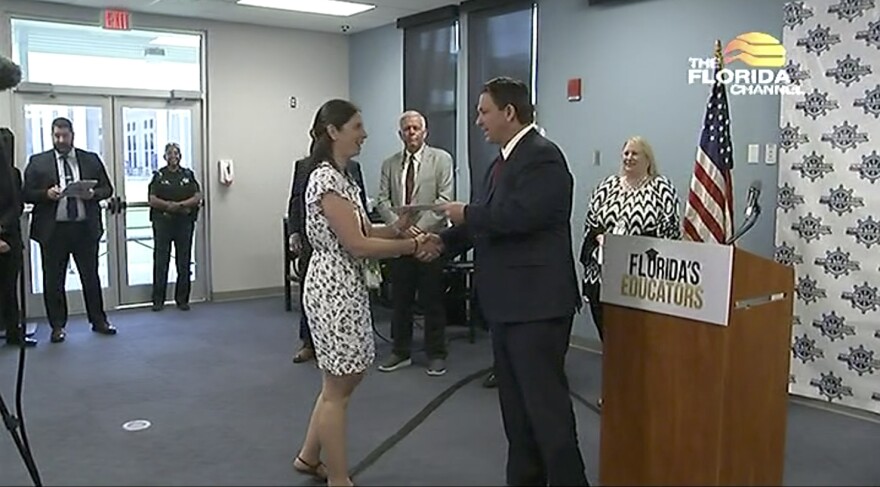 Gov. Ron DeSantis hands out $1,000 bonus checks to educators in Bay County on Wednesday, Aug. 12, 2021.