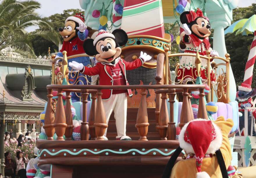 Disney characters Mickey and Minnie Mouse perform on a float for a Christmas parade at a press preview at the Tokyo Disneyland in Urayasu, suburban Tokyo Monday, Nov. 7, 2022. Special Disney character performance will be held at the Disneyland and Tokyo DisneySea from Nov. 8 through Christmas Day.  (Yoshikazu Tsuno/Pool Photo via AP)