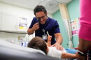 FILE - Pediatrician Irving Phillips examines a 16-month-old boy at a CommuniCARE+OLE clinic, June 26, 2025, in Davis, Calif. (AP Photo/Godofredo A. Vásquez, File)
