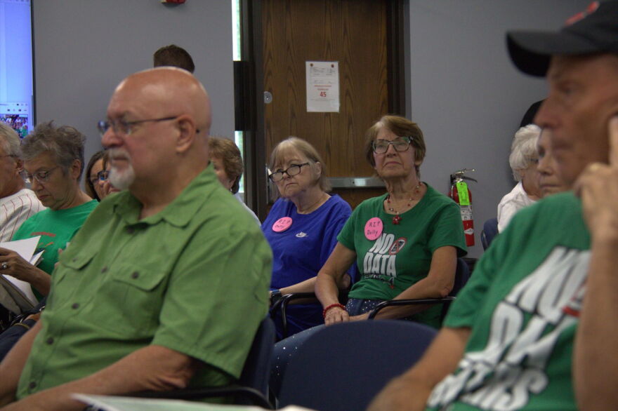 Clinton resident Carol McGuire, center, and others have been attending city council meetings for months to give input on the city's data center ordinance.