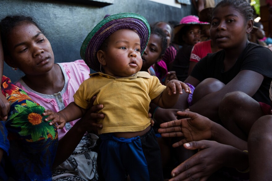 A mother and child wait outside the Marie Stopes clinic in Ambohitsara, Madagascar.