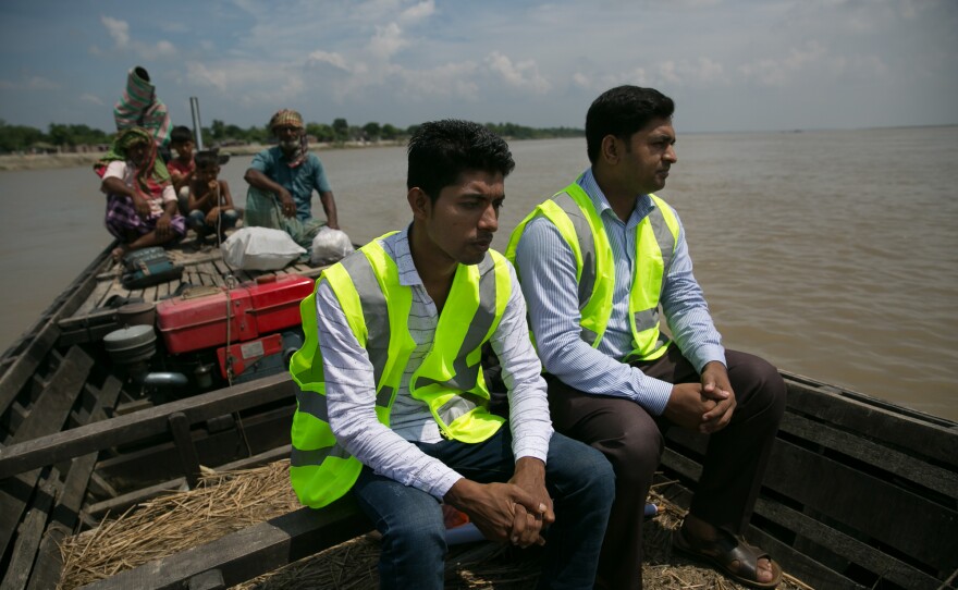 Teledaktar workers go to set up their session on a char in Rajshahi, Bangladesh. They carry laptops, a prescription printer and basic medical tools to areas that are otherwise cut off from professional health services.