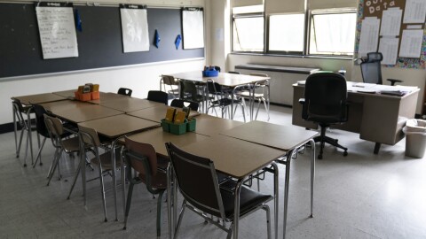 Desks fill a classroom in a high school.