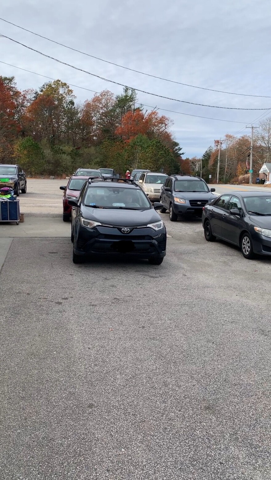 Cars were double-parked down the block outside a RICAN food distribution.