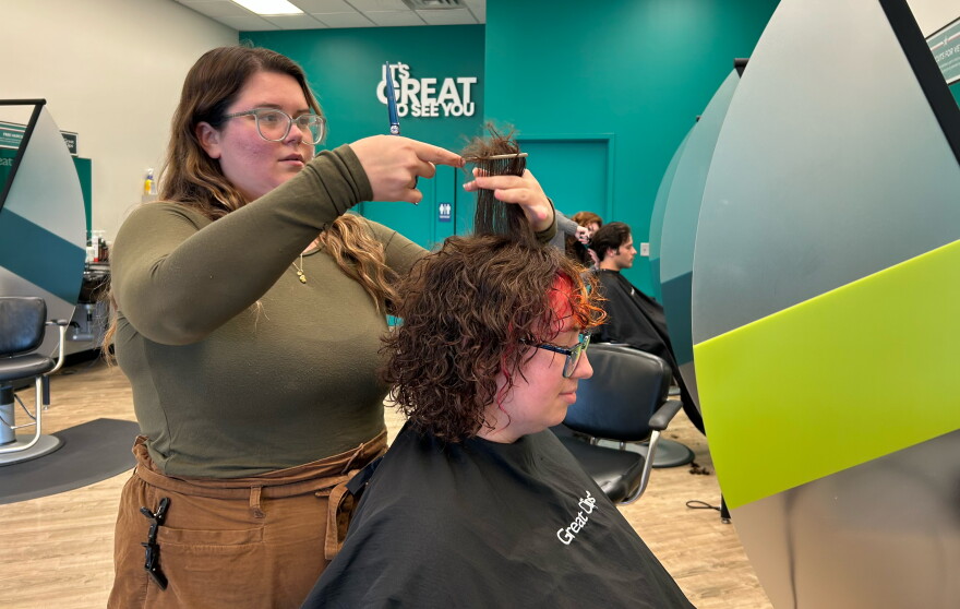 Teya Heller styles a customer's hair at Great Clips in Dickson City.