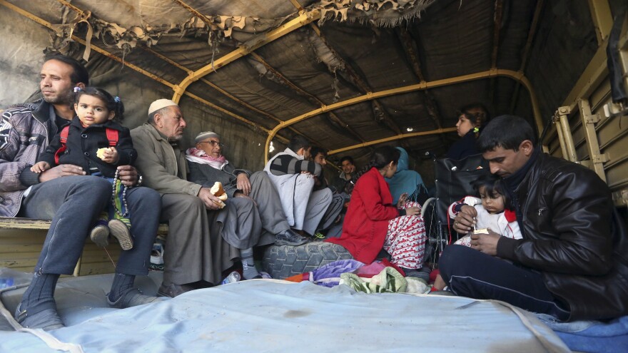 Iraqi civilians are loaded onto a truck Thursday to be taken to safety amid ongoing fighting between the Iraqi security forces and the Islamic State in Ramadi, 70 miles west of Baghdad. More than two weeks after central Ramadi was declared liberated, Iraqi forces are still battling pockets of ISIS militants on the edge of the city.