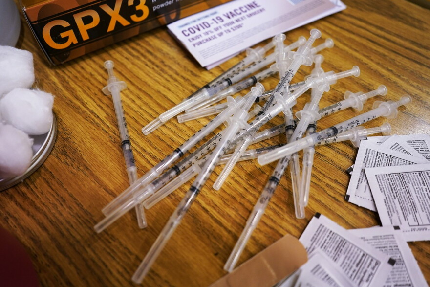 Prepared Pfizer COVID-19 vaccine syringes are seen at London Middle School in Wheeling, Ill.
