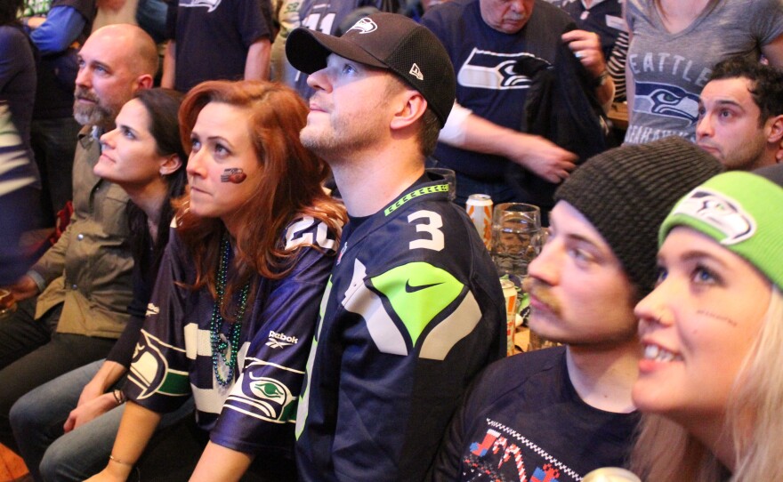 Stunned Seahawks fans at Altstadt in Pioneer Square watch as Seahawks go down to defeat in Sunday’s Superbowl.