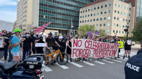 Protestors in support of abortion rights block Lansing's July 4th parade, which was scheduled to begin at 11 a.m. Monday. City officials rerouted the procession, but parade vehicles were mostly overshadowed by the hundreds of abortion-rights demonstrators who eventually joined the march.