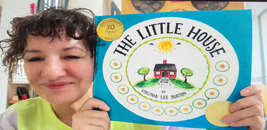 Sandra Cisneros holds up a copy of The Little House by Virginia Lee Burton.