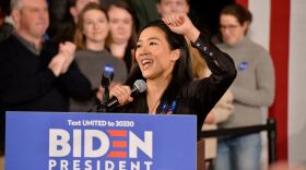 Former Olympian Michelle Kwan speaks before then-candidate Joe Biden at a rally in Manchester, N.H., on Feb. 8, 2020. On Wednesday President Biden said he'll nominate Kwan for ambassador to Belize.