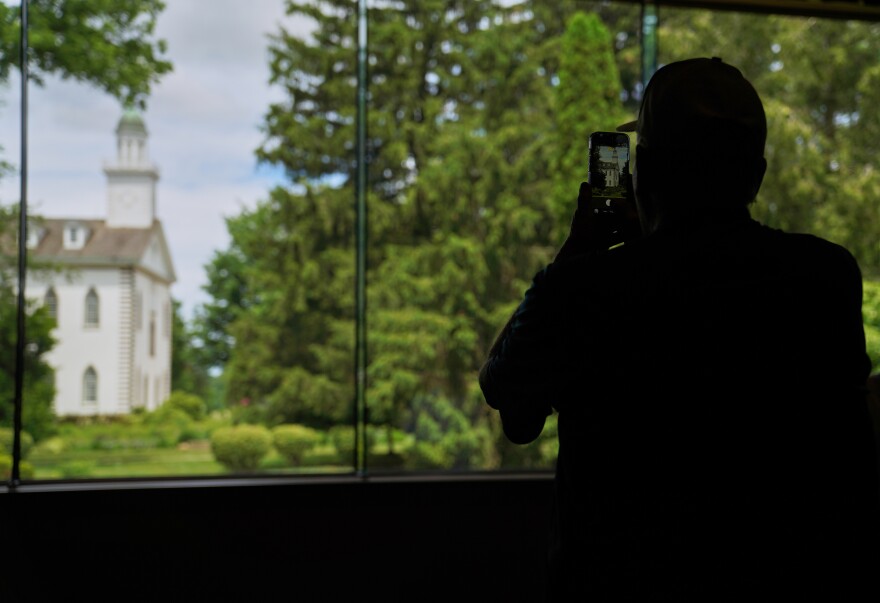 A visitor takes a photo of the Kirtland temple, a nearly two-century old sanctuary considered the first temple in the movement Joseph Smith founded, on Wednesday, June 15, 2026, in Kirtland, Ohio.