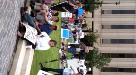 Protesters gather in a downtown park