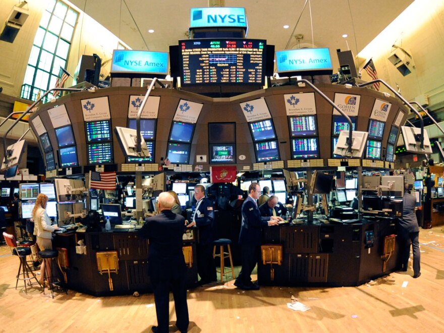 Traders gather on the floor of  the New York Stock Exchange.