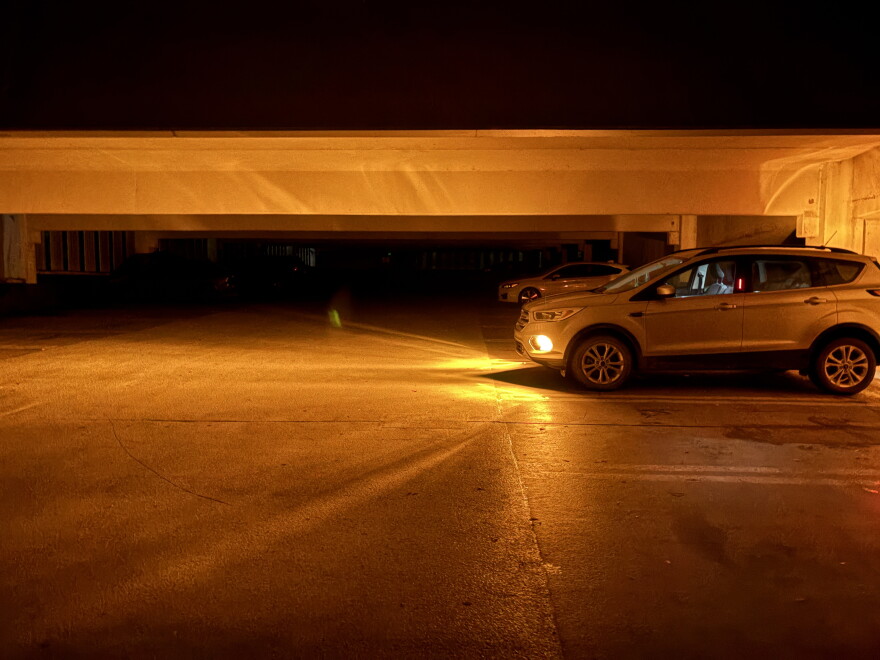 A vehicle’s headlights illuminate a dark parking garage on Michigan State University’s East Lansing campus during the widespread power outage Saturday night, Sept. 19, 2026.