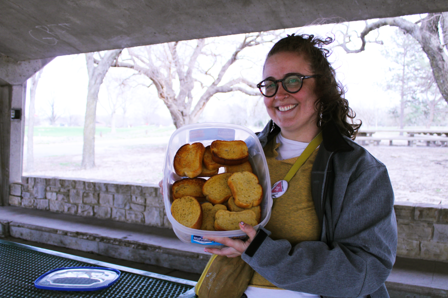 Jenny Pierce, the head of People's Pride ICT, holds a tray of garlic bread for their event "Gays Eating Garlic Bread in the Park."
