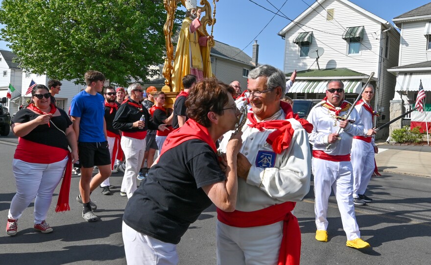 A woman kisses the St. Ubaldo relic which is a piece of Ubaldo's lung.