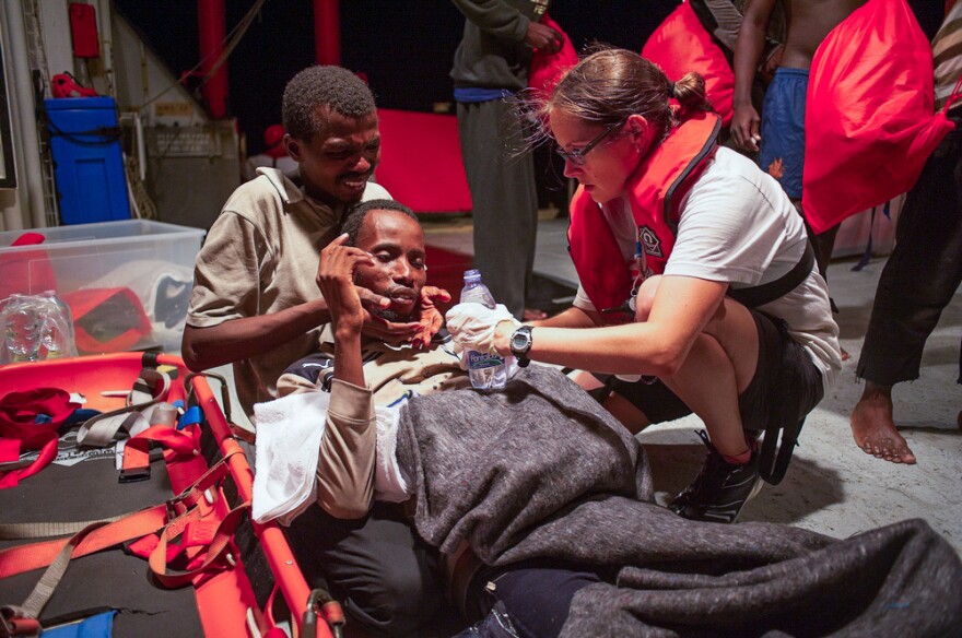 On the rescue ship Aquarius, Sarah Giles cares for a refugee from Senegal who was crossing the Mediterranean in an inflatable rubber boat. Giles is a doctor with Doctors Without Borders.