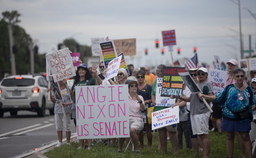People gather along U.S. 41 in Fort Myers on Saturday morning, October 17, 2026, to advocate for change ahead of the mid-term elections. Organizers estimate about 1,000 people came out for the event.