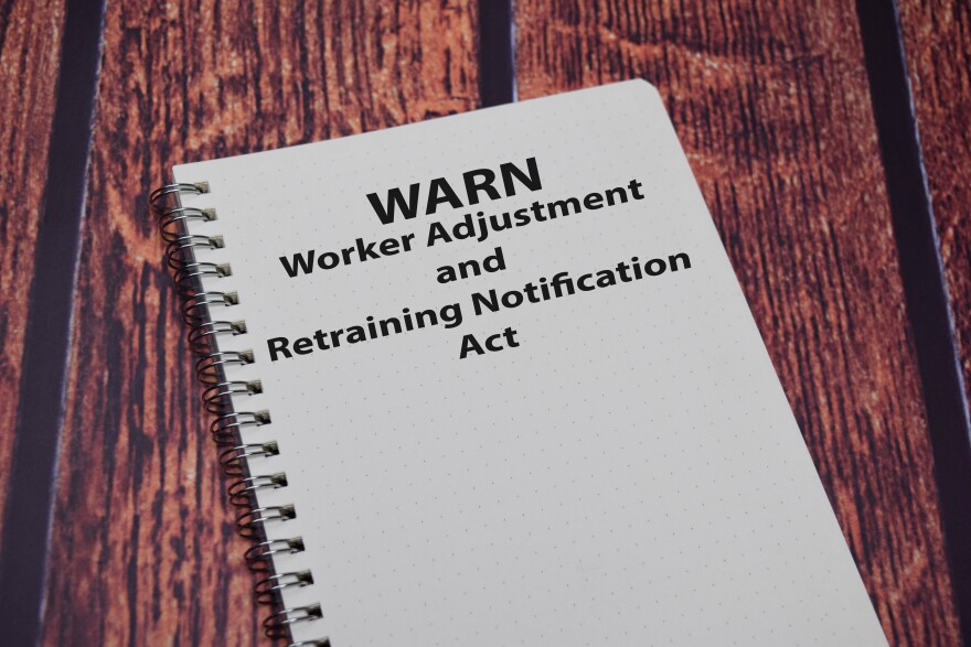 A book about the Worker Adjustment & Retraining Notification Act on a wooden table.