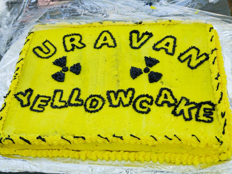 The star of the picnic is a brightly decorated yellow cake, made in homage to yellowcake uranium ore and the the nearby neon yellow signs declaring the area radioactive.